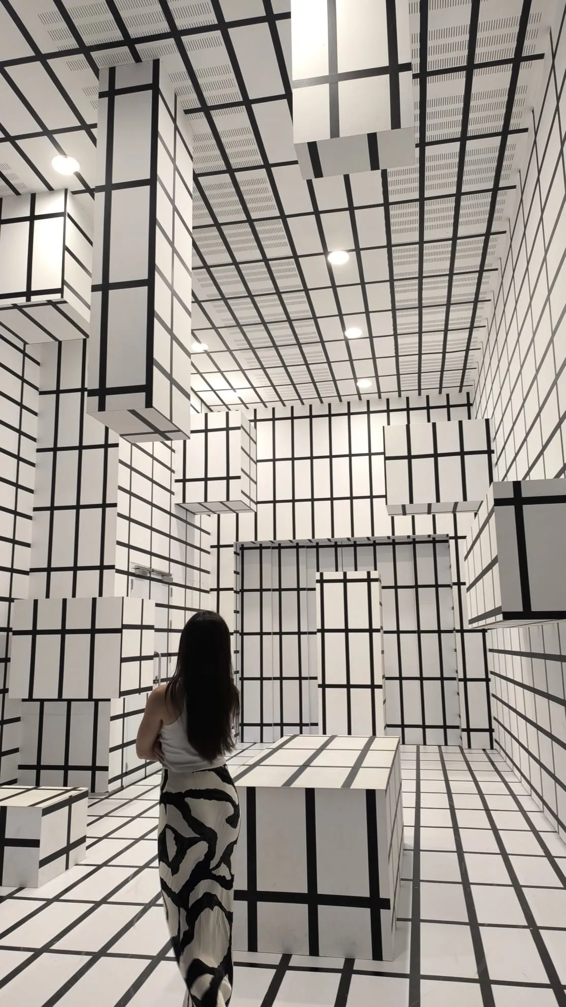 Valentina in a black and white grid art installation